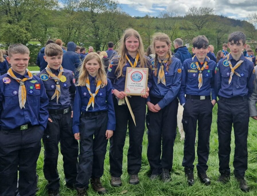 Scouts from the troop in uniform, holding their plaque after the county shield competition